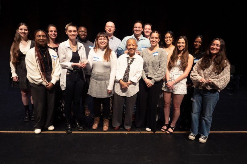 A group of students pose for a photo with Nikki Giovanni