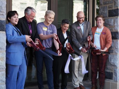 Virginia Tech representatives cut the ribbon in front of Lavender House to symbolically launch the new living learning community