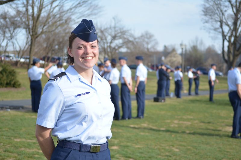 Smiling cadet with others out of focus in the background