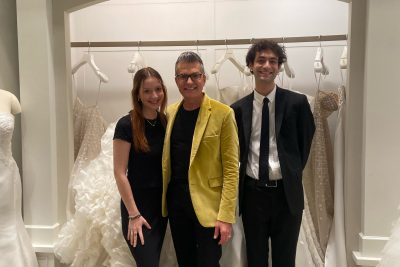 Dylan Spedaliere (right), a Virginia Tech student, interned at Kleinfeld Bridal last summer. He is pictured with Randy Fenoli (middle), a bridal designer at Kleinfeld, and Mariana Elizabeth. Photo by Brandi Hill. 