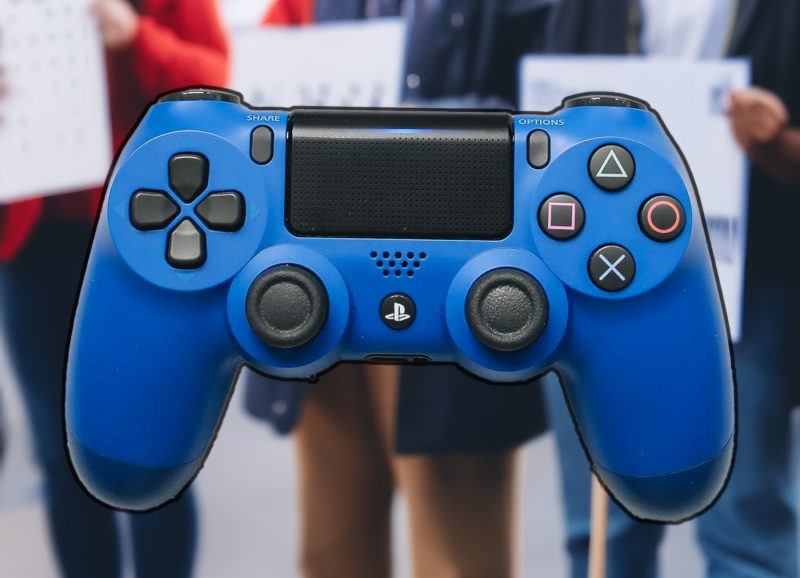 A video game controller with a picket line in the background. Image courtesy Virginia Tech/Pexels